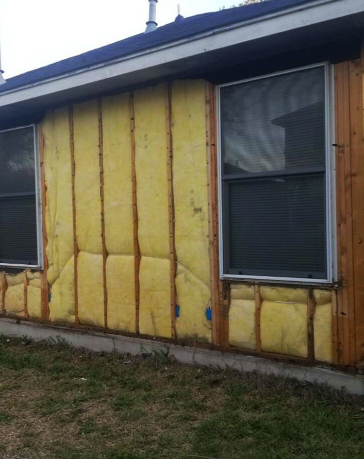 Home without Siding, Yellow Insulation Exposed